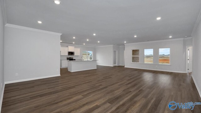 unfurnished living room featuring dark wood-style floors, recessed lighting, ornamental molding, and baseboards