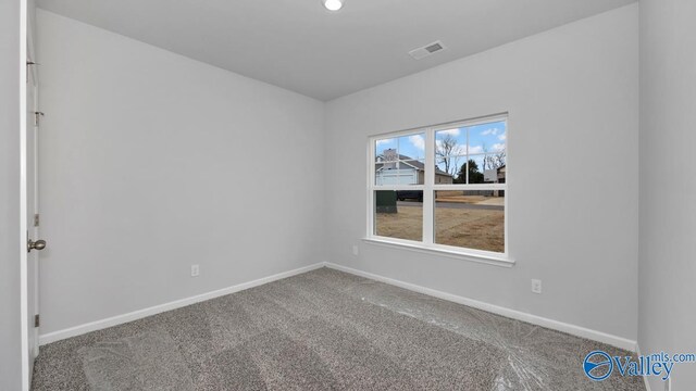 carpeted empty room with baseboards and visible vents