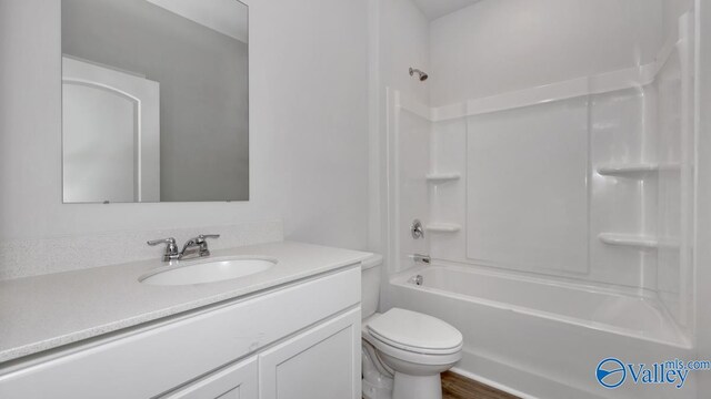full bath featuring toilet, vanity, and washtub / shower combination