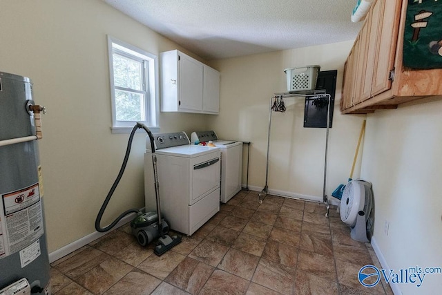 laundry area featuring cabinet space, baseboards, washer and clothes dryer, and water heater