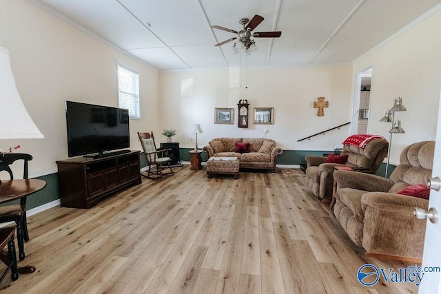 living room with ceiling fan, ornamental molding, and light wood-style flooring