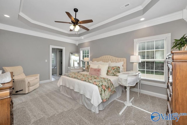 bedroom with a tray ceiling, ceiling fan, and light colored carpet