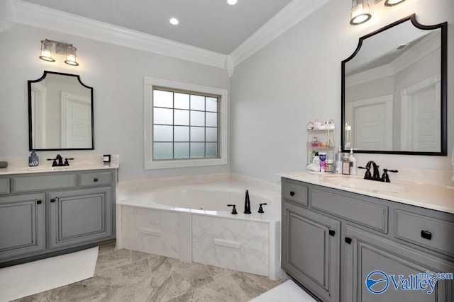 bathroom with tiled tub, vanity, and ornamental molding