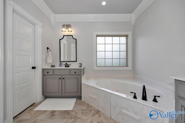 bathroom featuring vanity, ornamental molding, and tiled tub