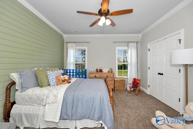 carpeted bedroom featuring multiple windows, crown molding, and ceiling fan