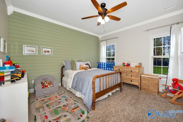 bedroom with ceiling fan, wood walls, ornamental molding, and carpet floors