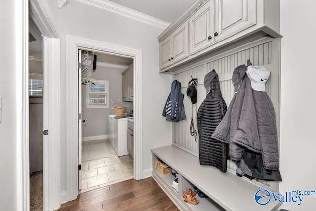 mudroom featuring washer and clothes dryer, dark hardwood / wood-style flooring, and ornamental molding