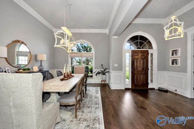 dining room featuring dark hardwood / wood-style flooring, ornamental molding, and an inviting chandelier