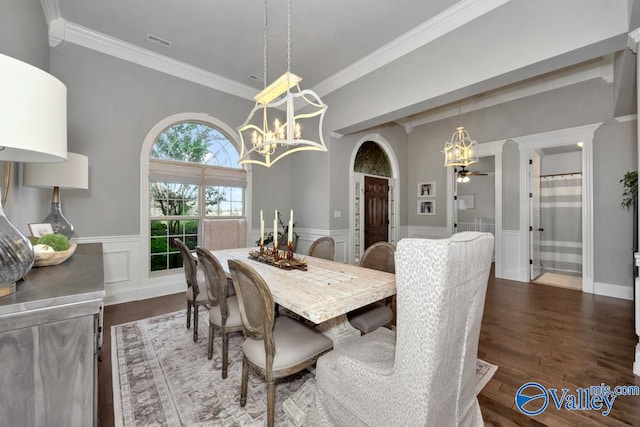 dining room with crown molding, ceiling fan with notable chandelier, and dark hardwood / wood-style floors