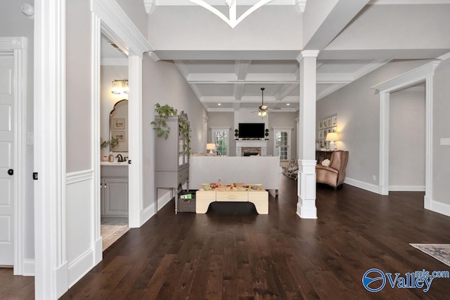 foyer with dark wood-type flooring, coffered ceiling, crown molding, ceiling fan, and beamed ceiling