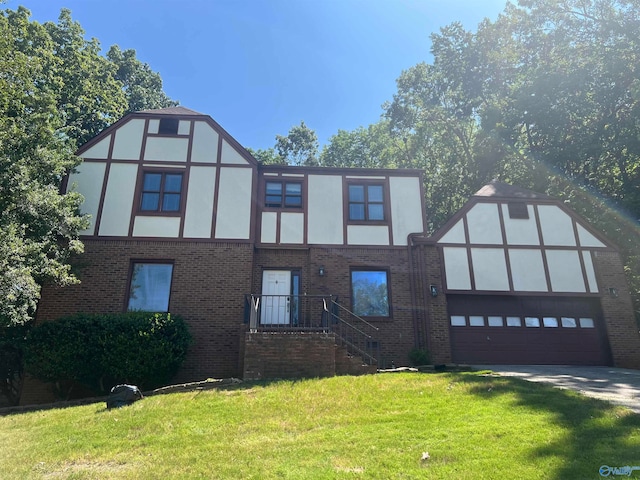 view of front of house with a front yard and a garage