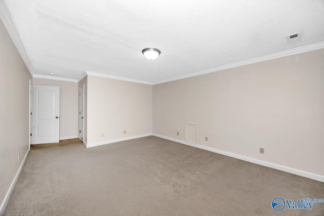 carpeted spare room featuring crown molding and baseboards