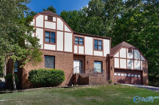 tudor home featuring a front lawn, brick siding, driveway, and stucco siding