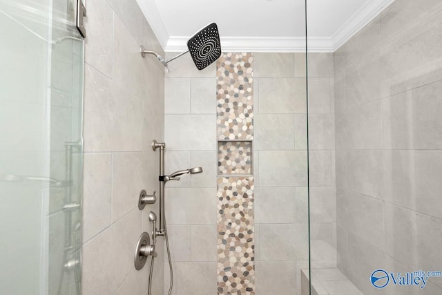 bathroom with tiled shower and ornamental molding