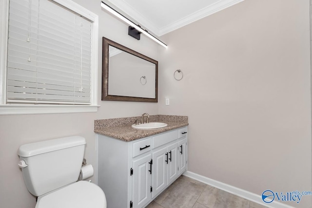 half bath with toilet, crown molding, tile patterned flooring, baseboards, and vanity