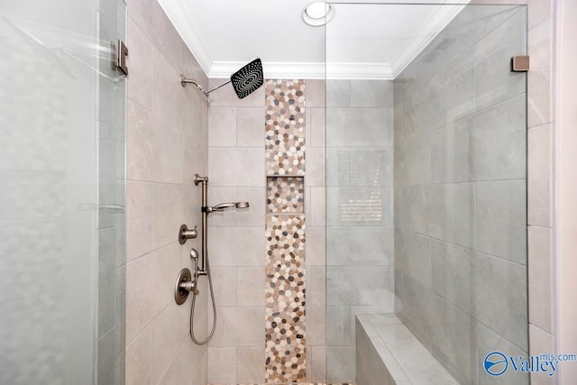 bathroom with crown molding and tiled shower