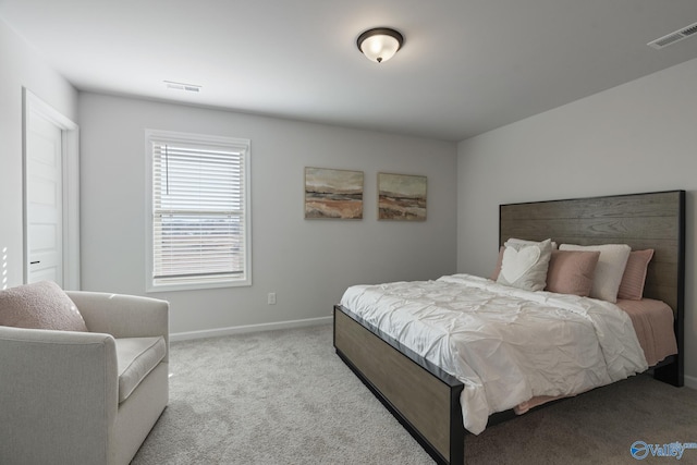 carpeted bedroom with baseboards and visible vents