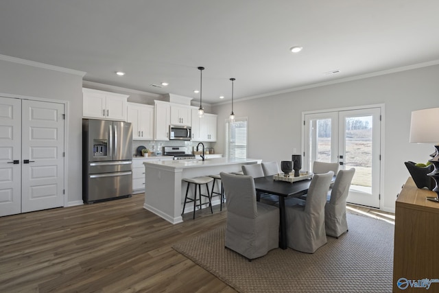 dining area with dark wood-type flooring, recessed lighting, french doors, and crown molding