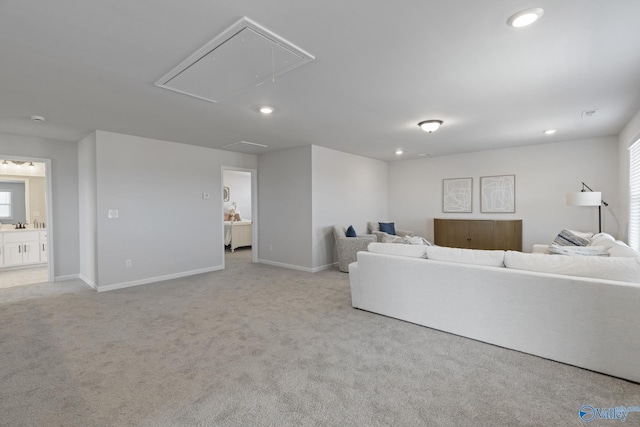 carpeted living area with attic access, recessed lighting, and baseboards