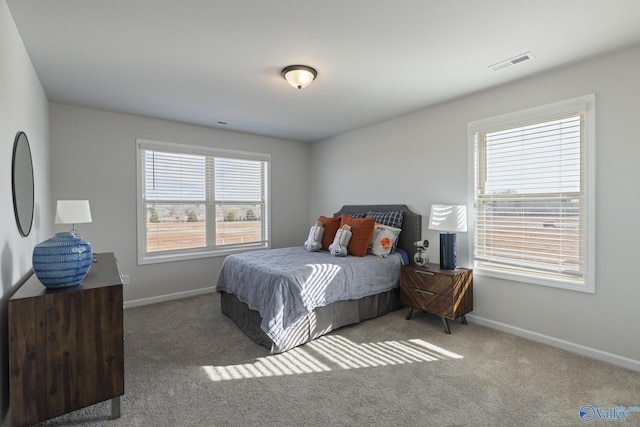 bedroom with baseboards, visible vents, and carpet flooring