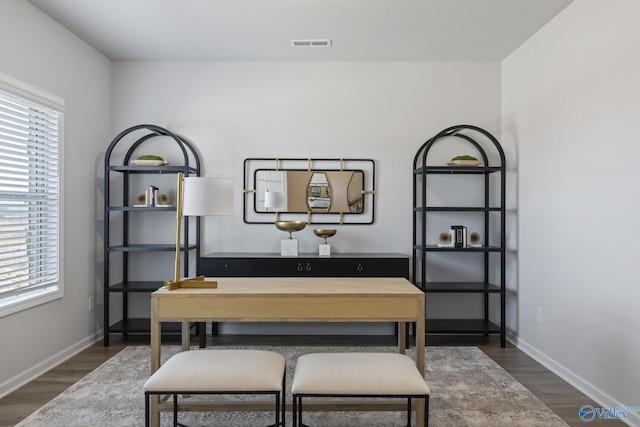 dining room featuring baseboards, visible vents, and wood finished floors