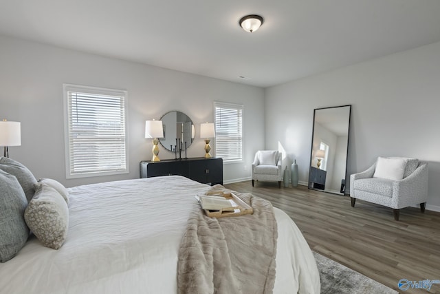 bedroom featuring baseboards and wood finished floors