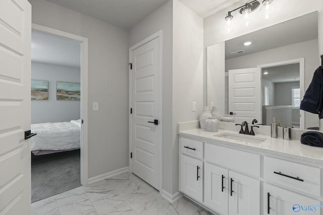 ensuite bathroom featuring recessed lighting, visible vents, vanity, baseboards, and marble finish floor