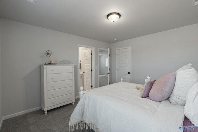 bedroom with dark carpet and baseboards