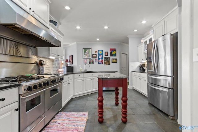 kitchen with under cabinet range hood, appliances with stainless steel finishes, white cabinets, and a sink