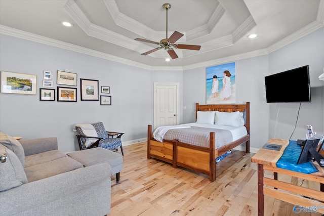 bedroom with light wood-type flooring, ornamental molding, recessed lighting, baseboards, and a raised ceiling