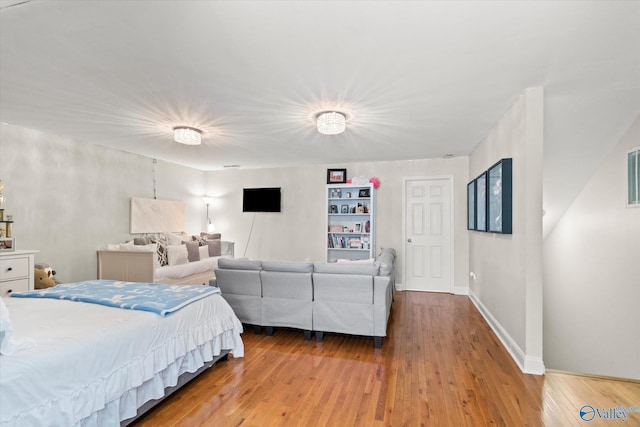 bedroom featuring baseboards and light wood-style floors