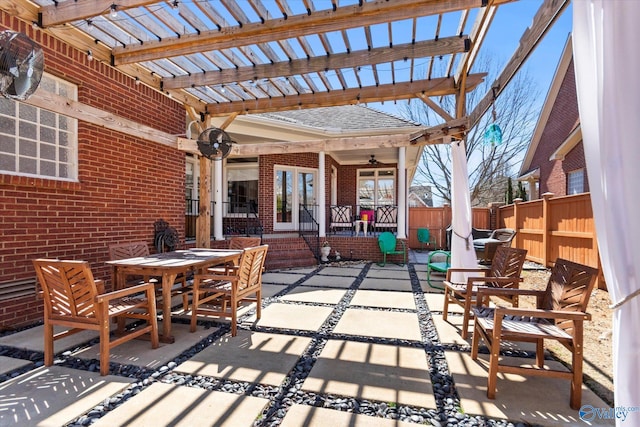 view of patio / terrace featuring outdoor dining area, fence, and a pergola