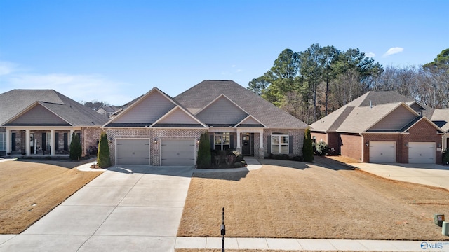 craftsman-style house featuring brick siding, an attached garage, and driveway