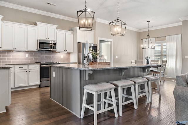 kitchen with visible vents, tasteful backsplash, appliances with stainless steel finishes, and dark wood finished floors