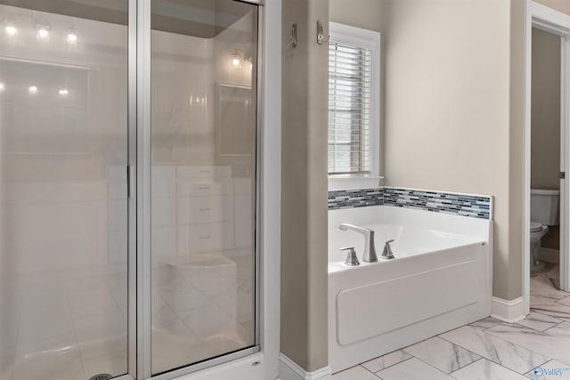 full bath featuring a garden tub, toilet, marble finish floor, and a shower stall