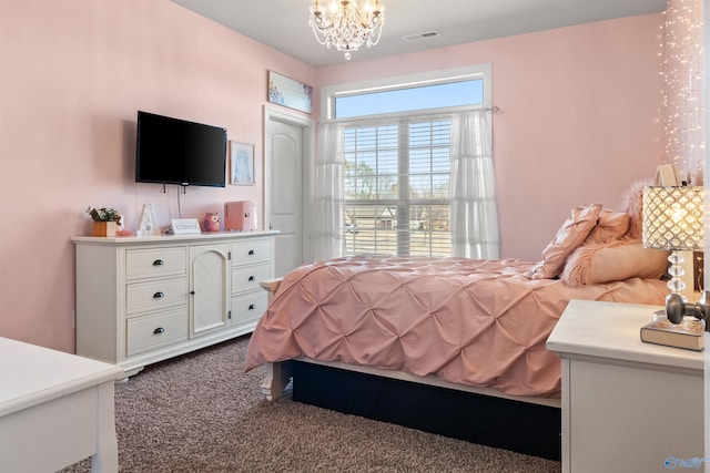 bedroom with carpet flooring, visible vents, and a chandelier