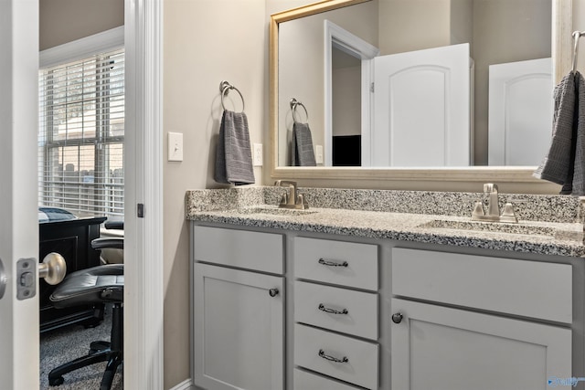 bathroom with a sink and double vanity