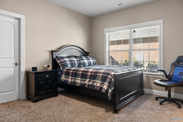 bedroom featuring light colored carpet, visible vents, and baseboards