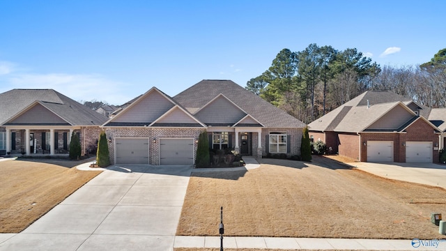 craftsman inspired home with a garage, brick siding, and driveway