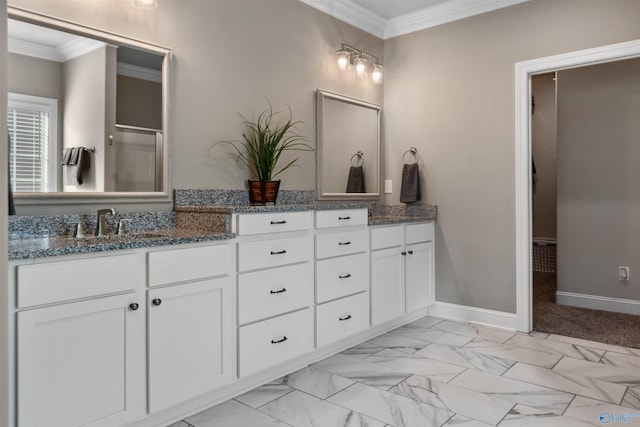 full bath with double vanity, marble finish floor, baseboards, and ornamental molding