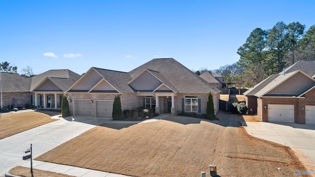 craftsman-style home featuring concrete driveway, an attached garage, and brick siding