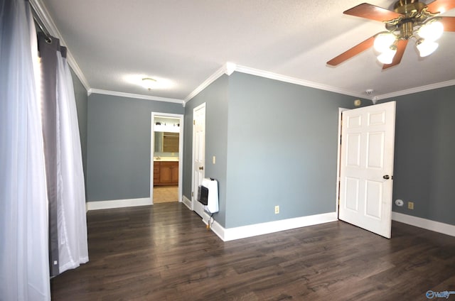 empty room with crown molding, ceiling fan, dark wood-type flooring, and heating unit