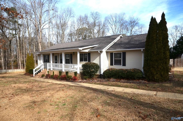 ranch-style home with a porch and a front yard