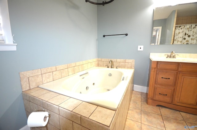 bathroom featuring tile patterned flooring, vanity, and a relaxing tiled tub