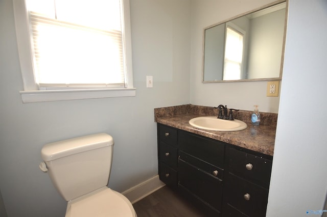 bathroom with vanity, hardwood / wood-style floors, and toilet