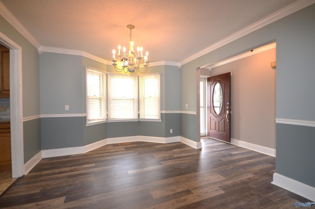 entrance foyer featuring crown molding, dark hardwood / wood-style floors, and an inviting chandelier