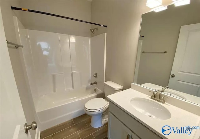 full bathroom featuring toilet, shower / bathing tub combination, hardwood / wood-style floors, and vanity