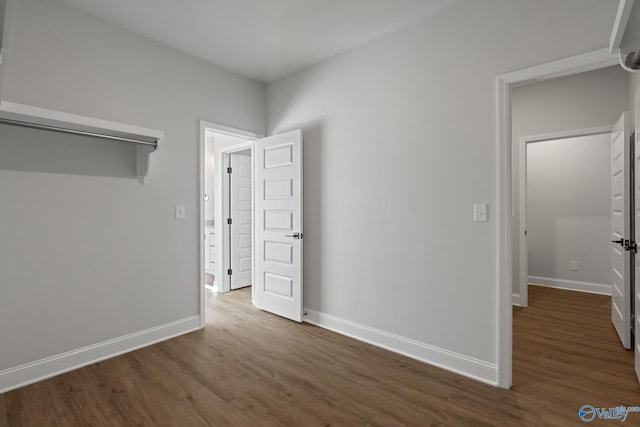 unfurnished room with dark wood-type flooring