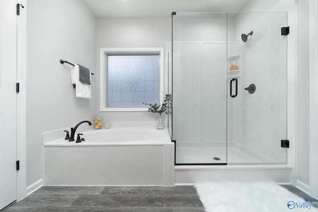 bathroom featuring shower with separate bathtub and hardwood / wood-style flooring