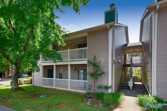 6616 Willow Pointe Dr Unit A, Huntsville, AL 35806 - view of home's exterior with a chimney, a balcony, stairway, and a porch